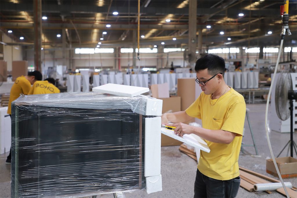 Interior furniture products are loaded into the container for shipment to the U.S. market.